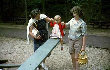 Laura on the teeter totter with Grandma Loretta and Mom